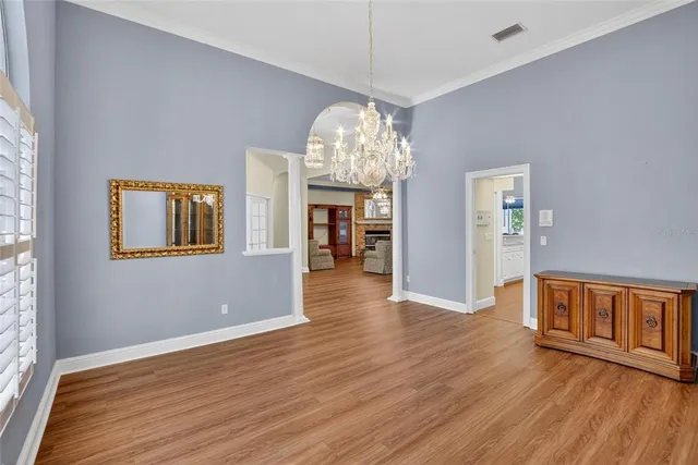 a view of a dining room with furniture wooden floor and a chandelier