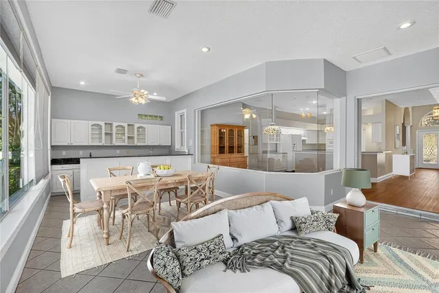 a bedroom with a bed chandelier and a window