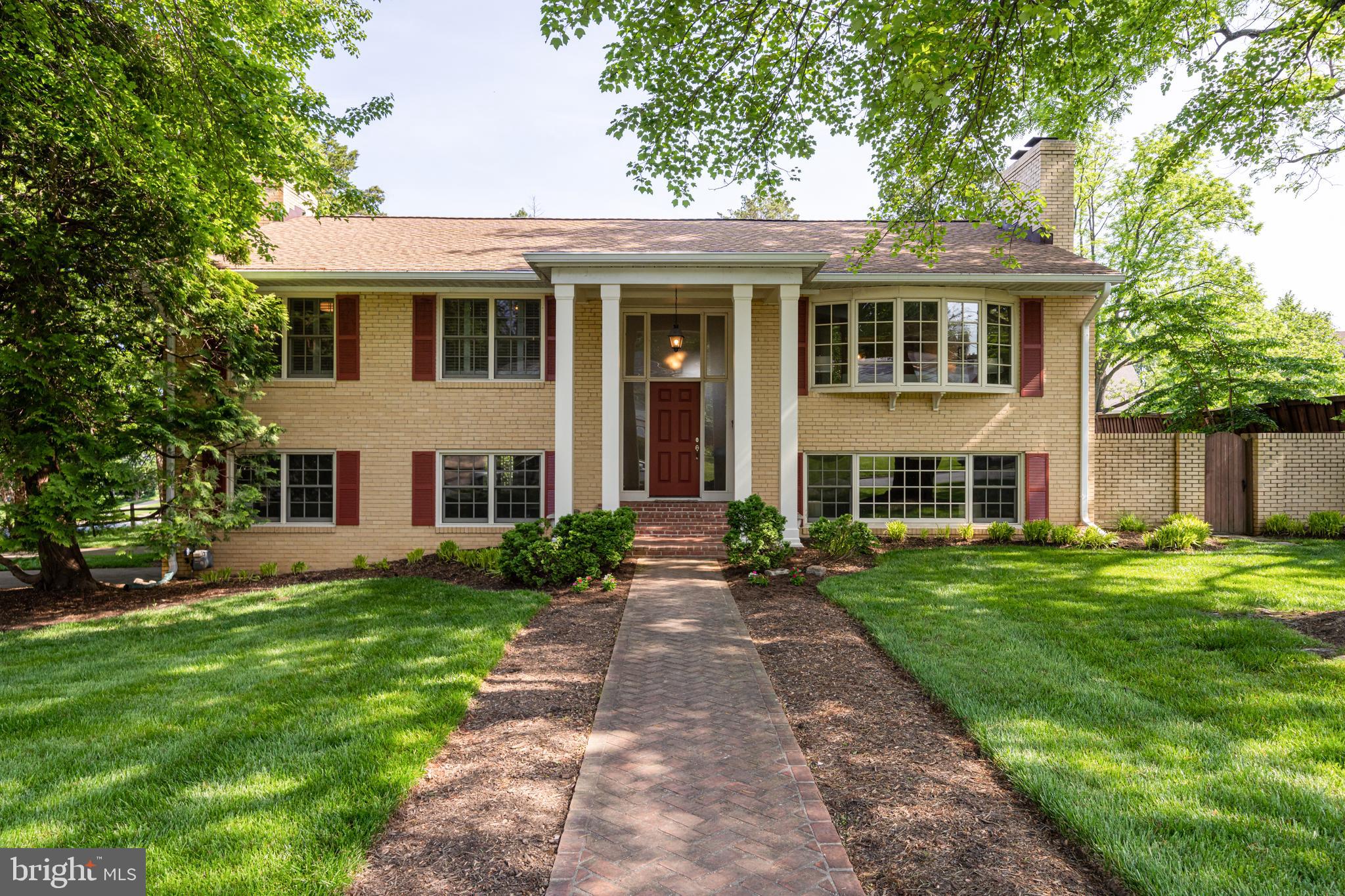 6166 Mori Street McLean, VA 22101 - Photo 1 of 48 a front view of a house with a garden