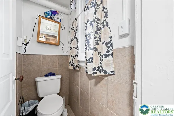 a white toilet sitting next to a bathroom sink