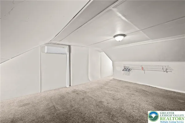 a view of a room with air conditioner and windows