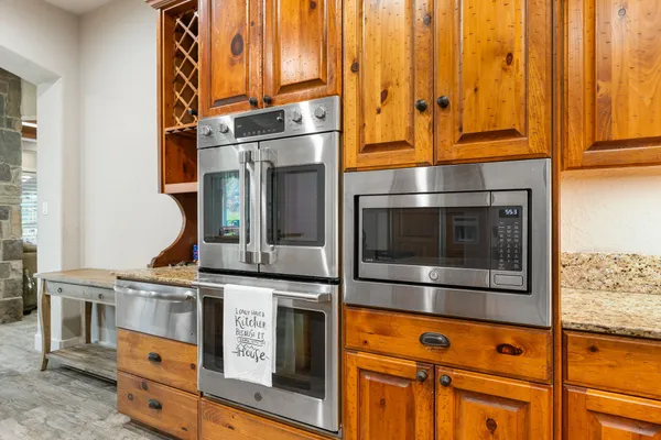 a kitchen with stainless steel appliances granite countertop a stove and a microwave