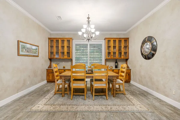 a dining room with wooden floor and a window