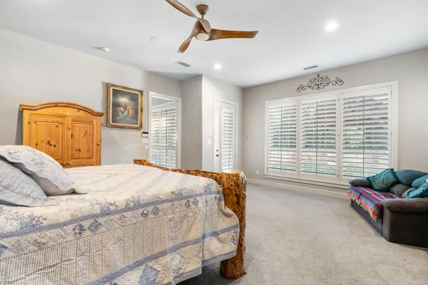 a bedroom with a bed couch and window