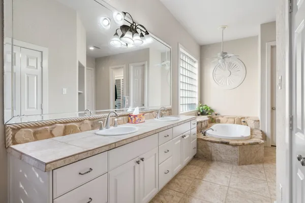 a bathroom with a sink double vanity and a mirror