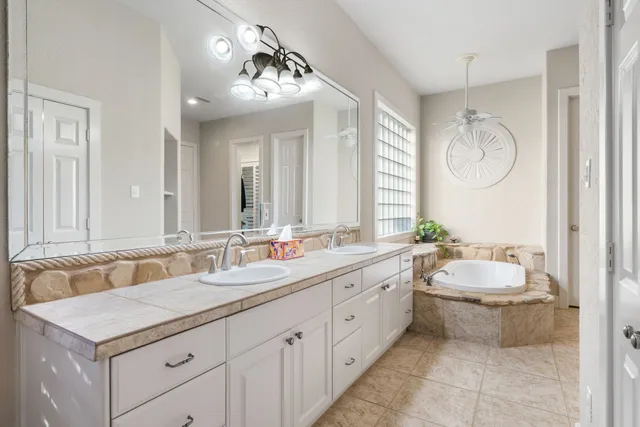 a bathroom with a sink double vanity and a mirror