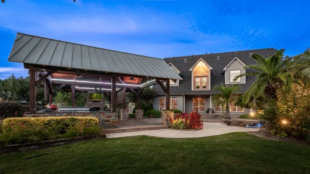 a view of a chairs and table in patio with a barbeque