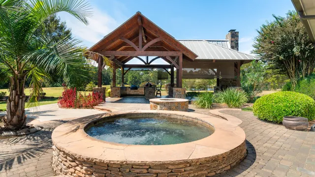 a swimming pool with outdoor seating yard and barbeque oven