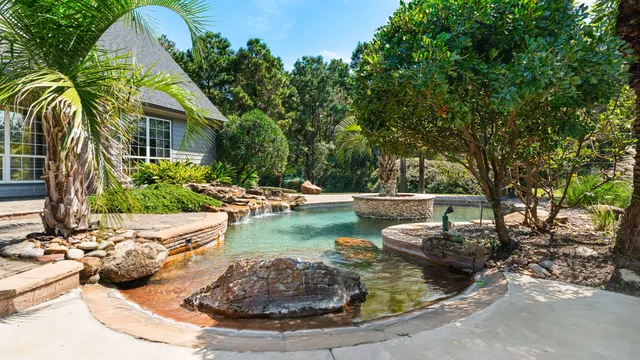 a view of a house with swimming pool and sitting area
