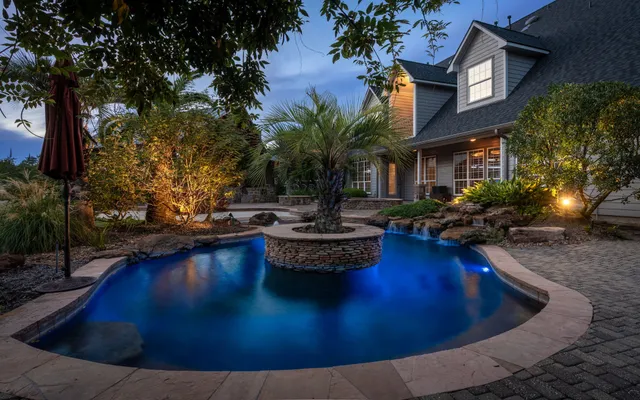 a view of a backyard with swimming pool