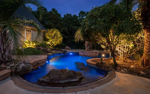 an aerial view of a house with a yard and swimming pool