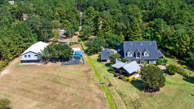 an aerial view of residential houses with outdoor space