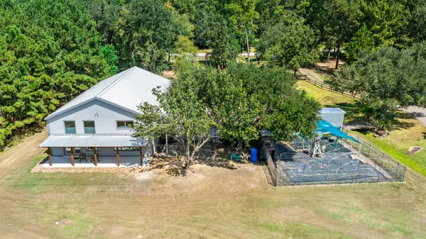 a view of a house with a backyard and a tree