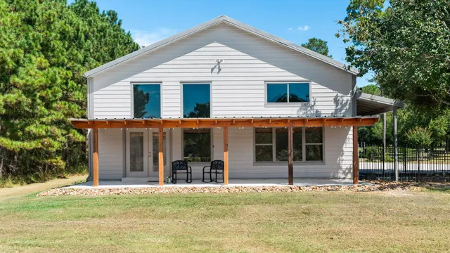 a house that has a tree in front of it