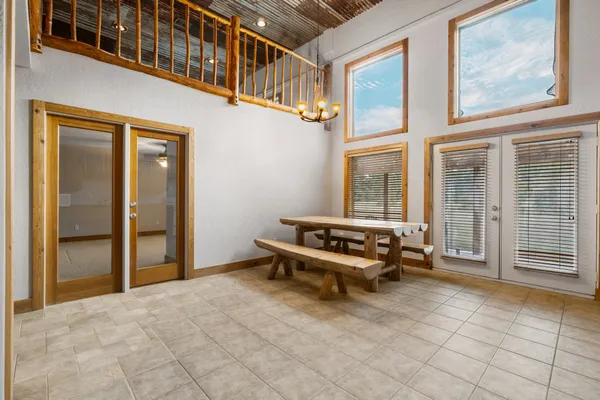 a backyard of a house with barbeque oven table and chairs