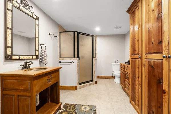 a bathroom with a sink a mirror and a shower
