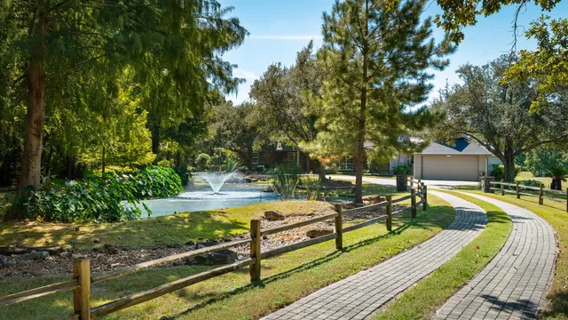 a large white building with a view of residential buildings