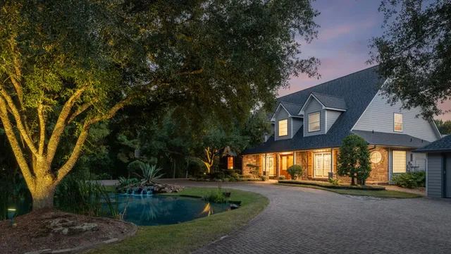 a view of a house with a yard and tree s