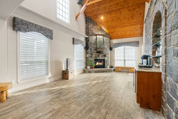 a view of a patio with a table and chairs and a barbeque