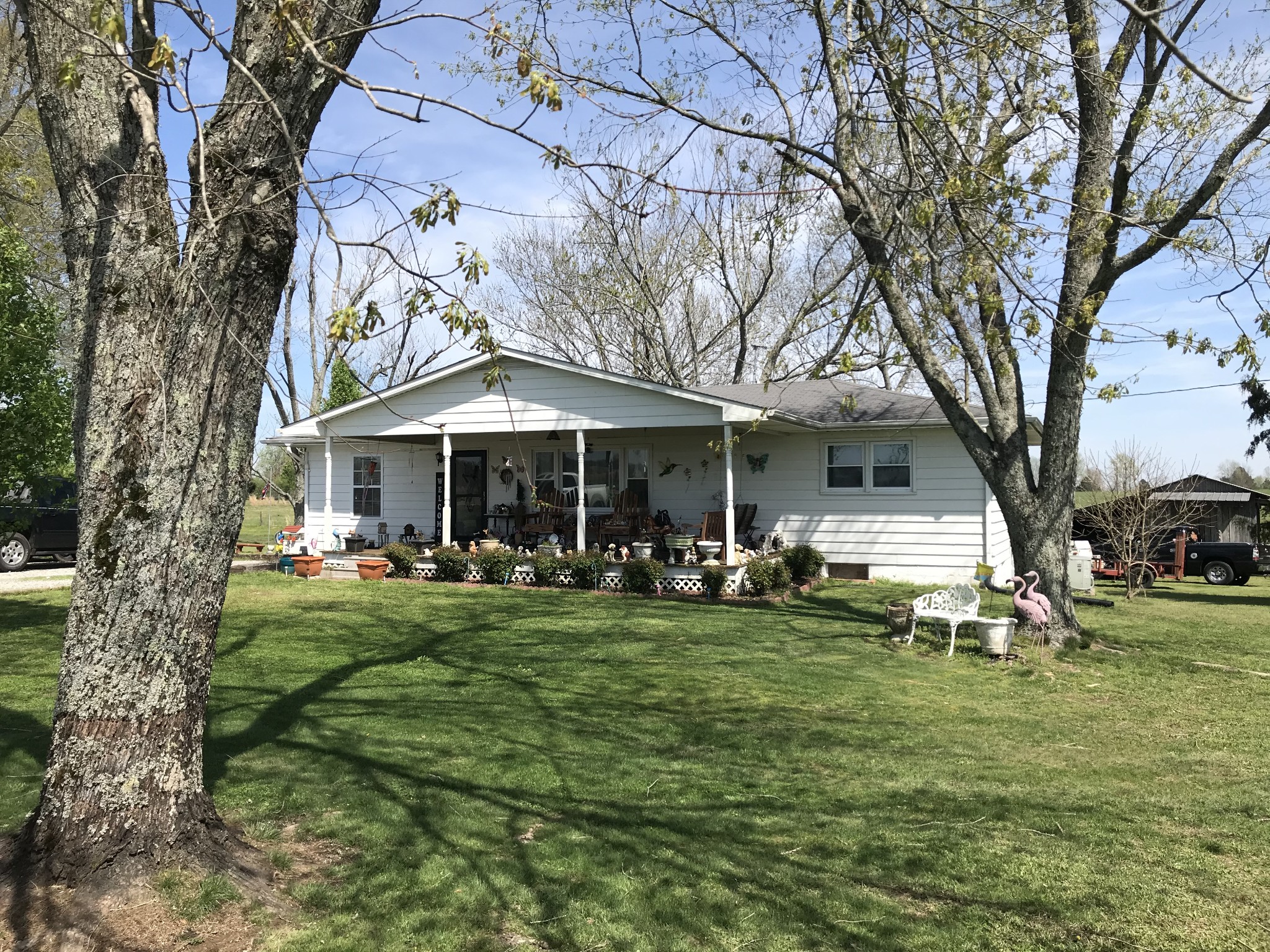 572 Rabbit Trail Road Leoma, TN 38468 - Photo 1 of 24 a front view of a house with a garden and trees