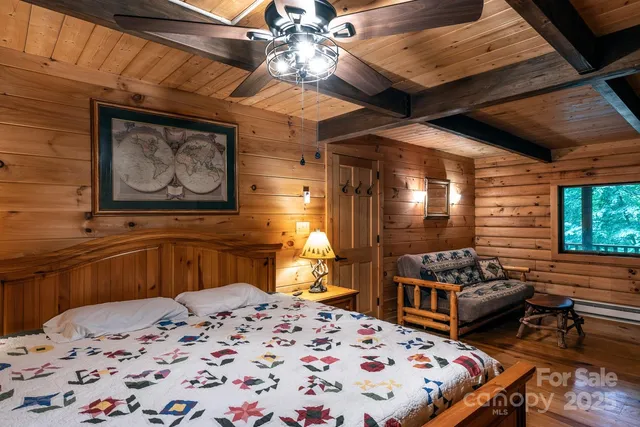 a bedroom with bed and wooden floor