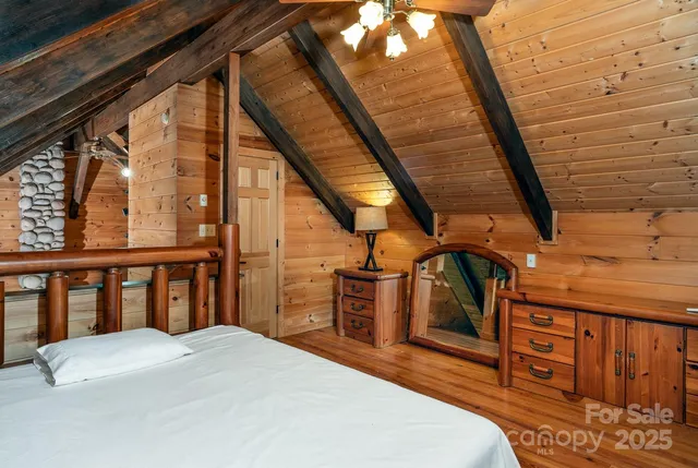 a bedroom with a bed next to a large window