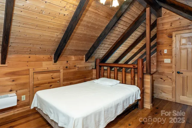 a bed sitting in a bedroom next to a bathroom