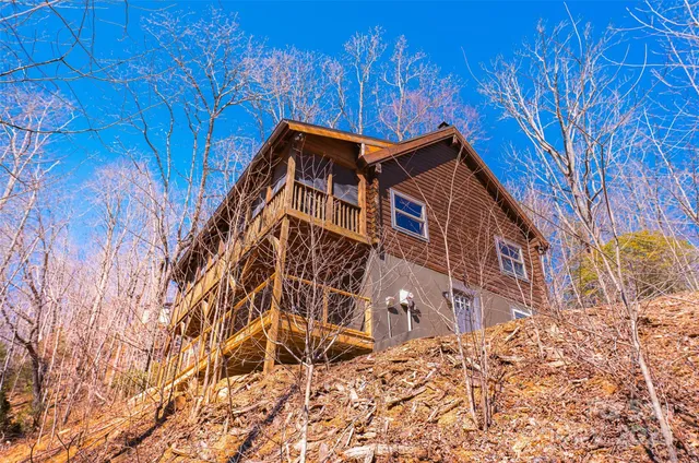 a view of a patio with table and chairs with wooden floor and floor to ceiling window
