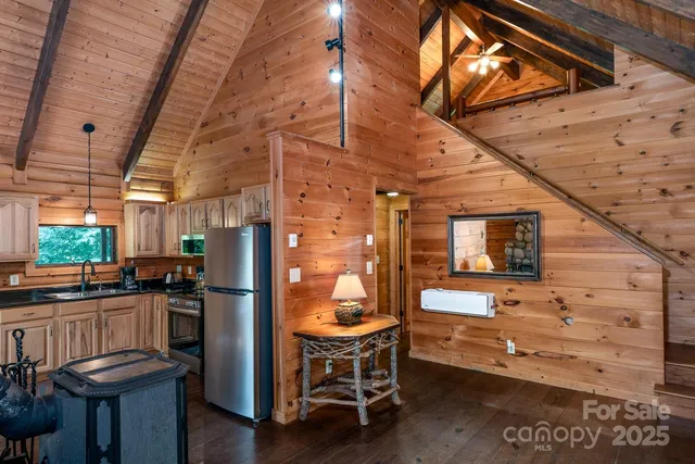 a view of a chairs in kitchen and a room of the house