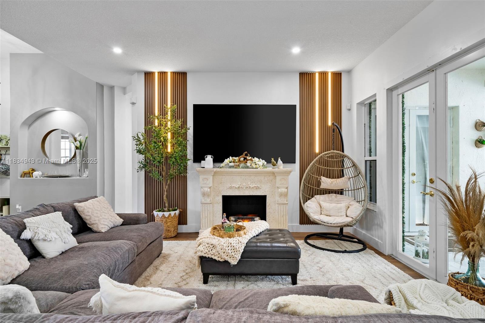 14501 Southwest 33rd Court Miramar, FL 33027 - Photo 11 of 91 a living room with furniture a fireplace and a flat screen tv