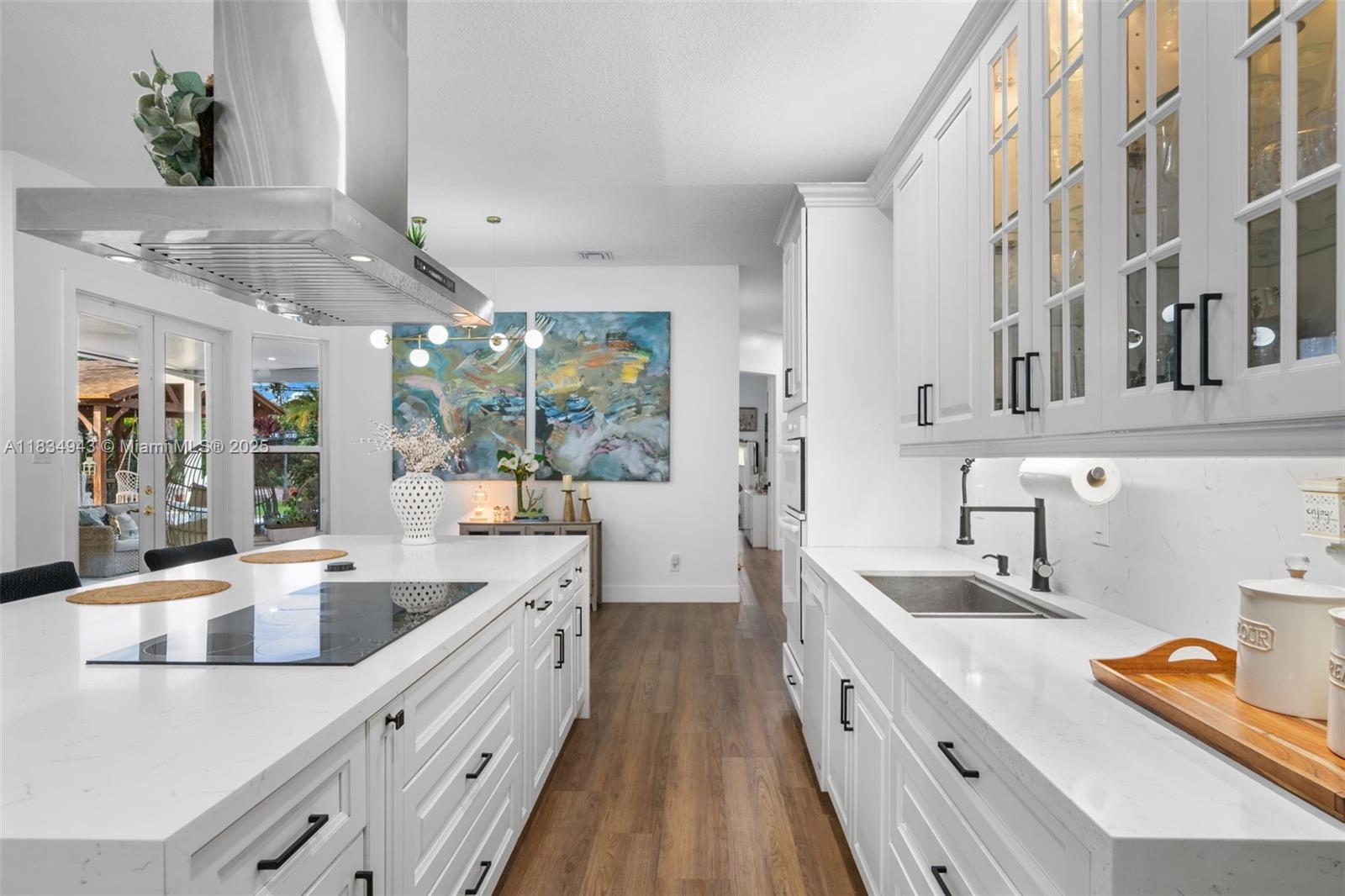 14501 Southwest 33rd Court Miramar, FL 33027 - Photo 13 of 91 a large white kitchen with stainless steel appliances granite countertop a lot of counter space and wooden floors