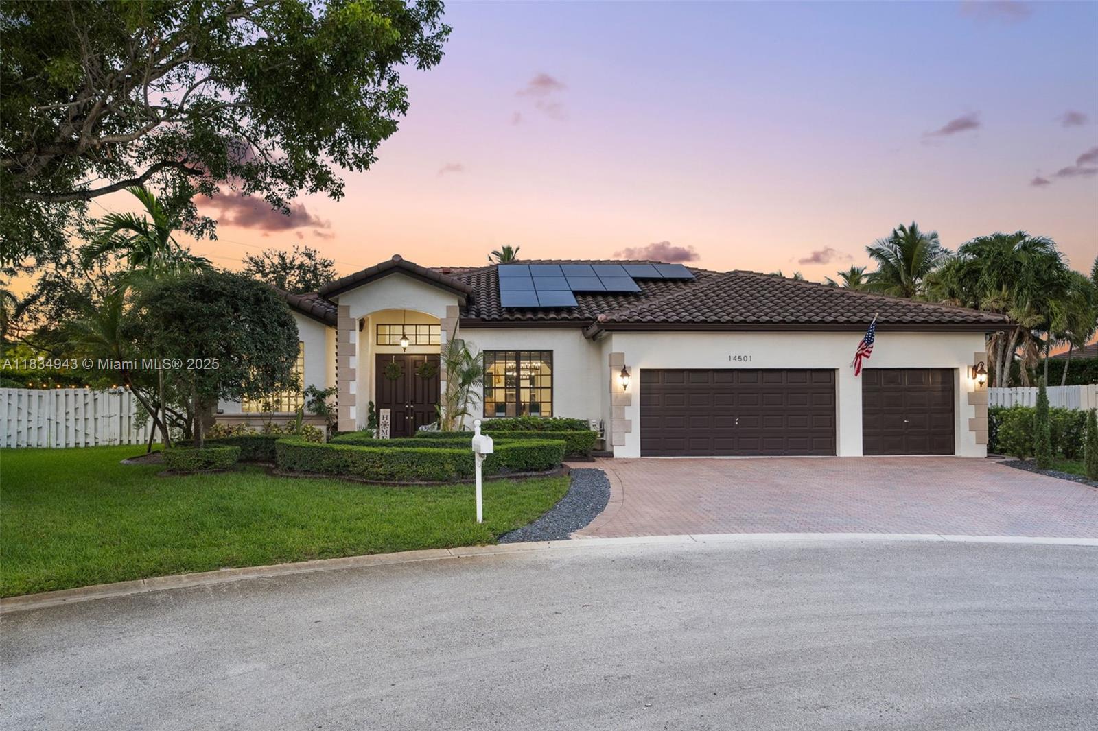 14501 Southwest 33rd Court Miramar, FL 33027 - Photo 3 of 91 a front view of a house with a yard and garage