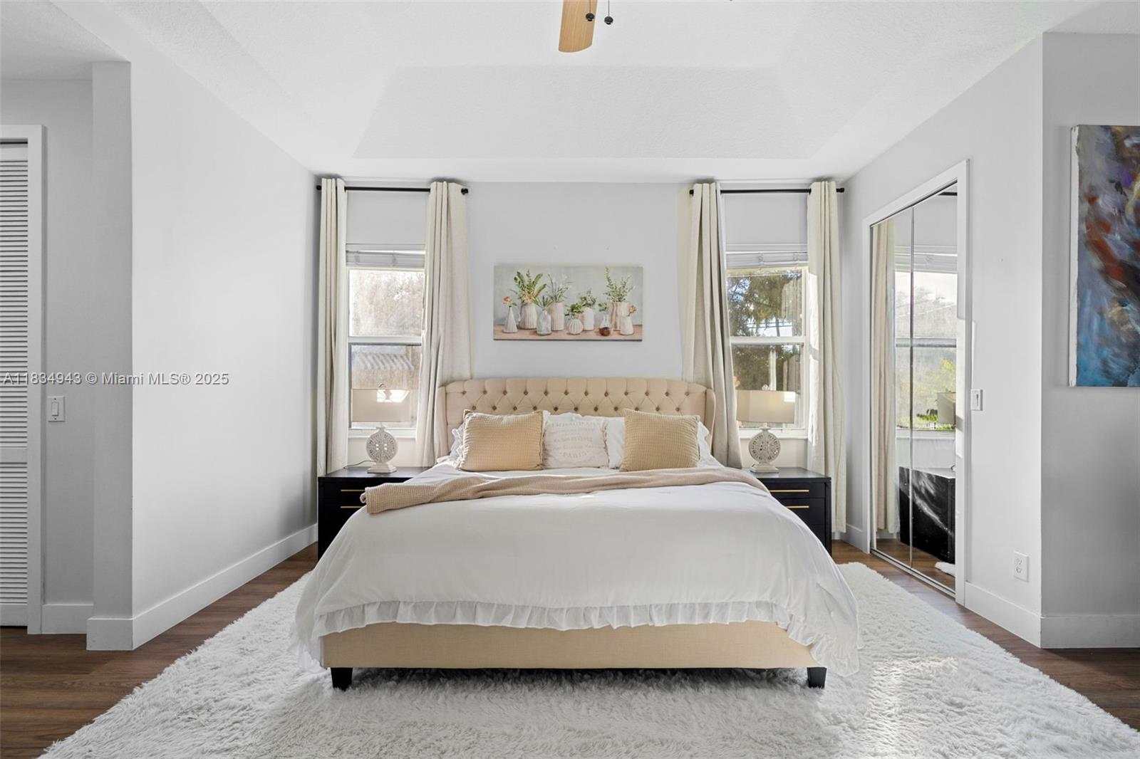 14501 Southwest 33rd Court Miramar, FL 33027 - Photo 32 of 91 a spacious bedroom with a bed and a painting on the wall