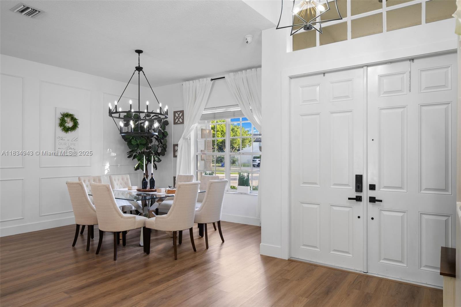 14501 Southwest 33rd Court Miramar, FL 33027 - Photo 4 of 91 a view of a dining room with furniture and chandelier
