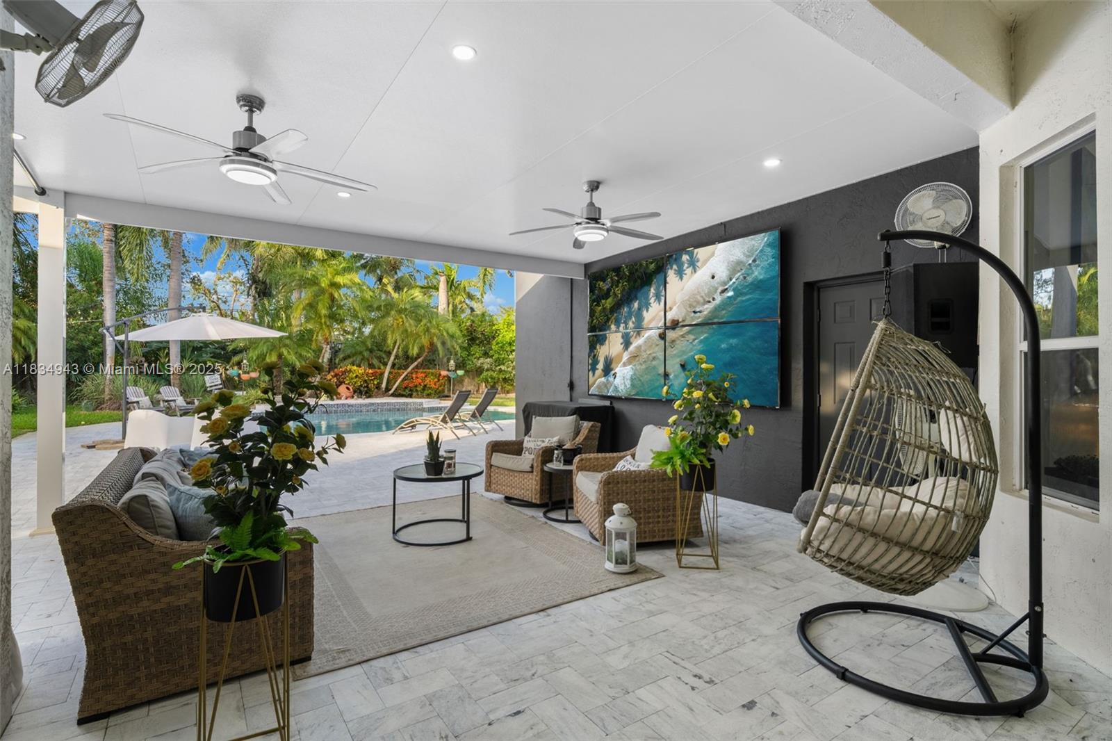 14501 Southwest 33rd Court Miramar, FL 33027 - Photo 41 of 91 a living room with furniture and a chandelier