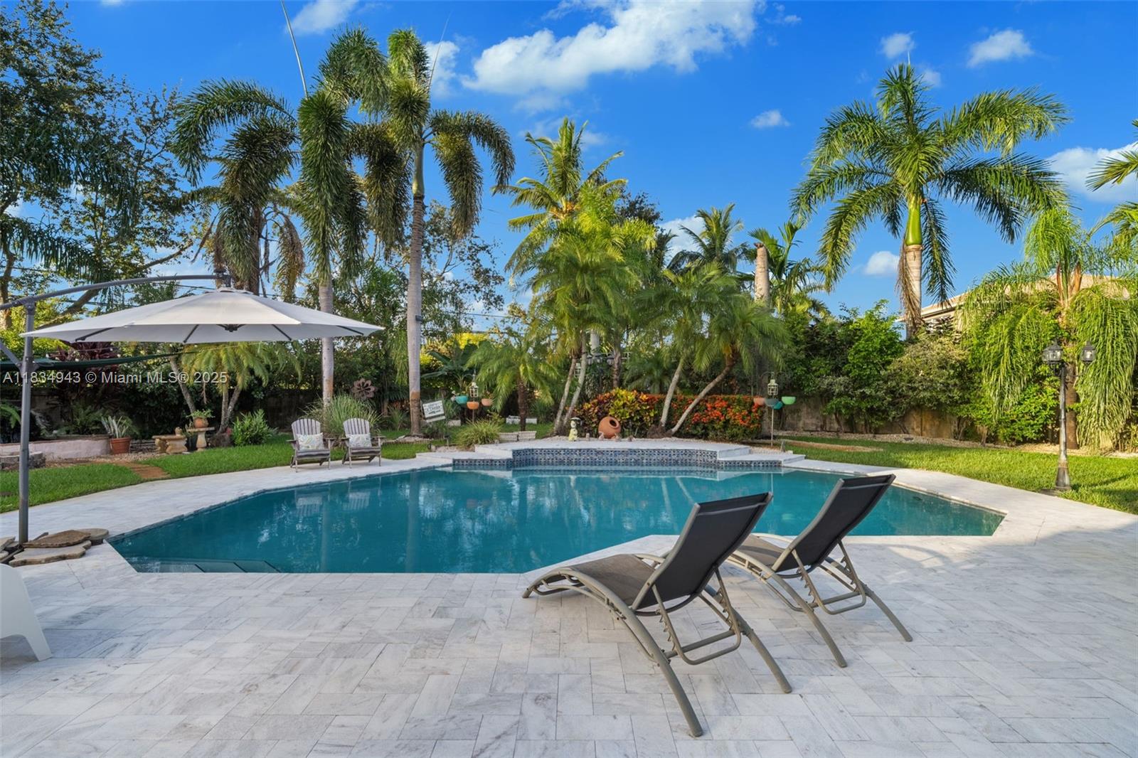 14501 Southwest 33rd Court Miramar, FL 33027 - Photo 44 of 91 a view of backyard with swimming pool and outdoor seating