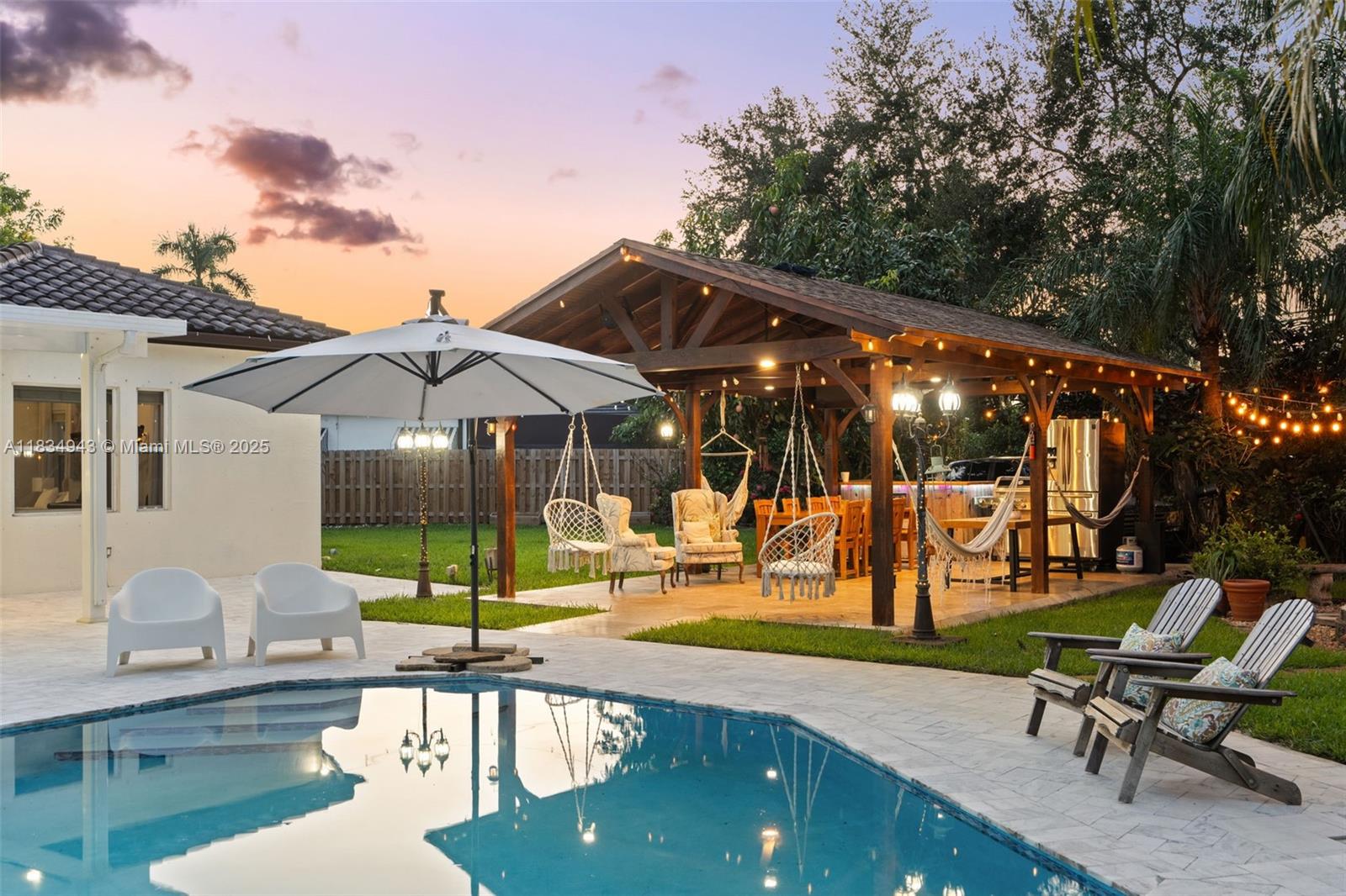 14501 Southwest 33rd Court Miramar, FL 33027 - Photo 55 of 91 a view of a patio with a table and chairs under an umbrella