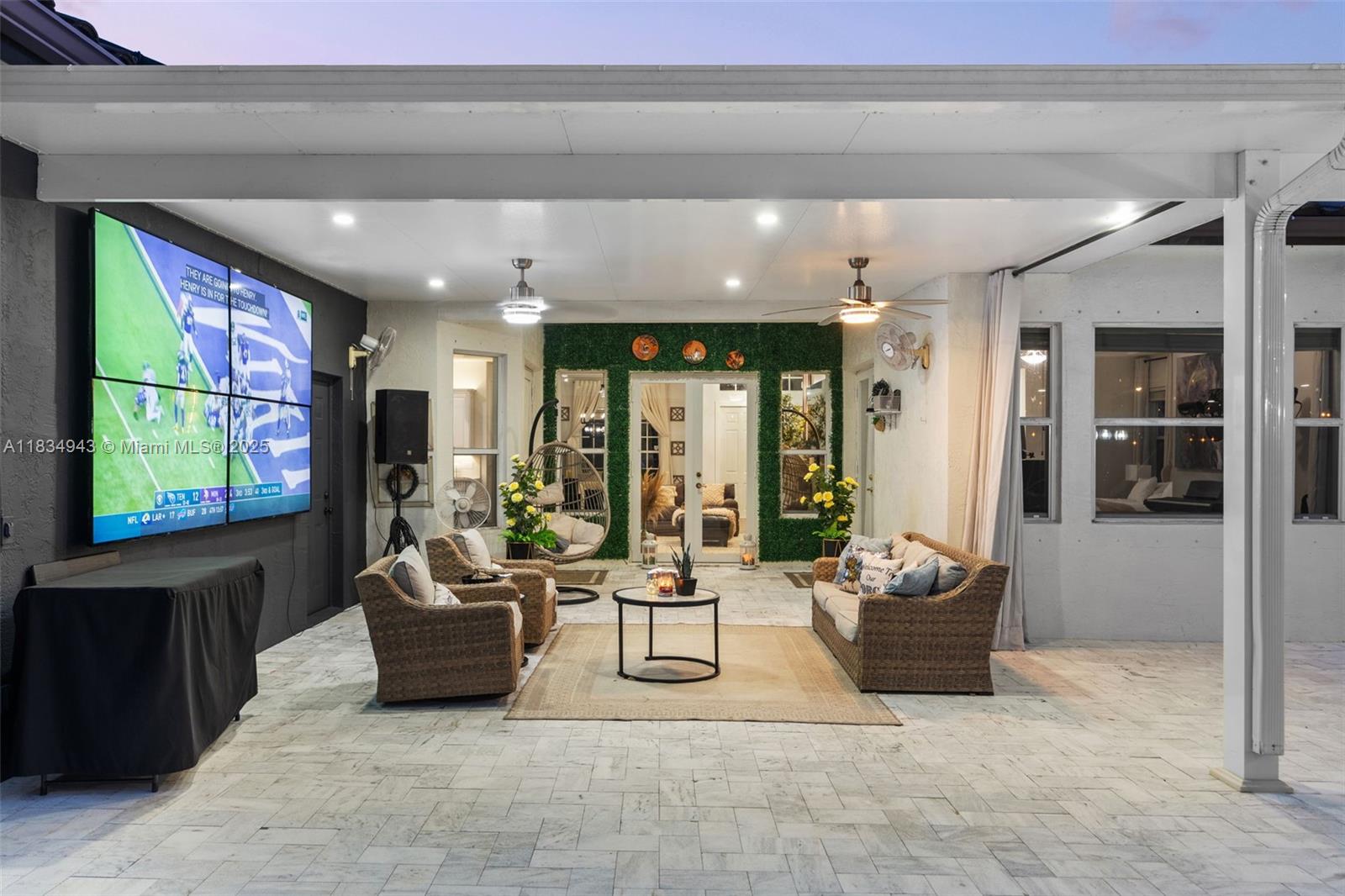 14501 Southwest 33rd Court Miramar, FL 33027 - Photo 63 of 91 a living room with furniture a flat screen tv and floor to ceiling window