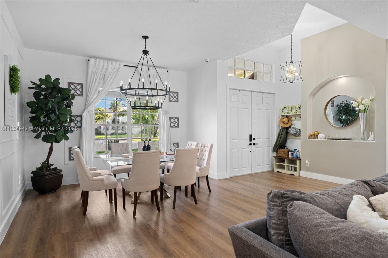 14501 Southwest 33rd Court Miramar, FL 33027 - Photo 7 of 91 a view of a dining room with furniture wooden floor and chandelier