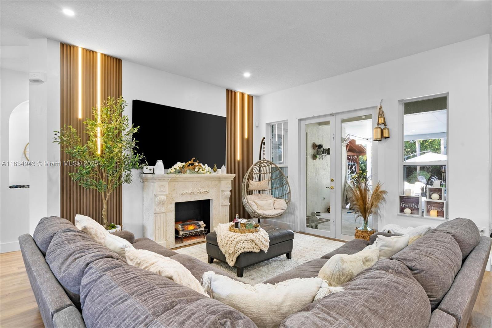 14501 Southwest 33rd Court Miramar, FL 33027 - Photo 8 of 91 a living room with furniture a fireplace and a flat screen tv