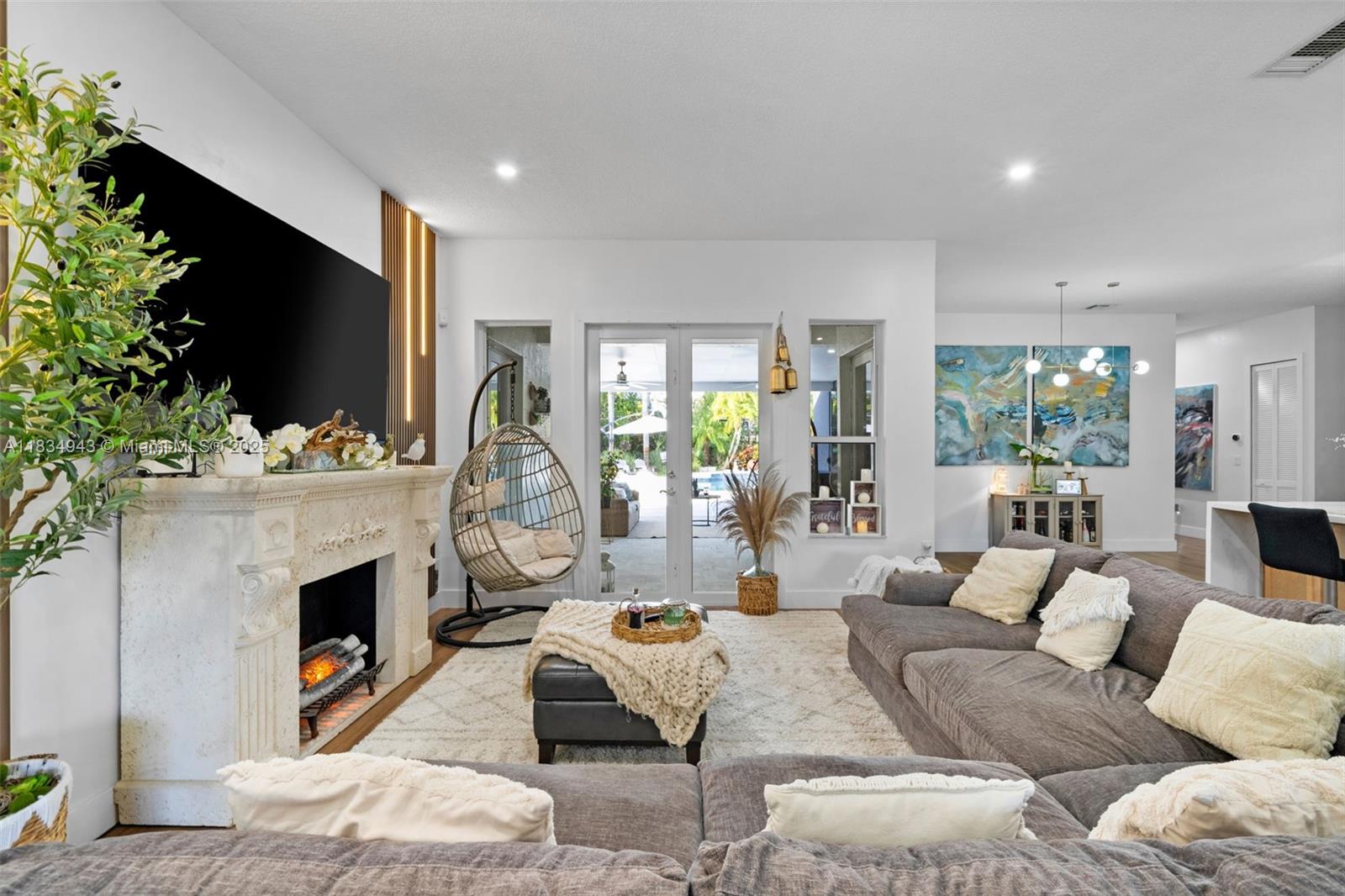 14501 Southwest 33rd Court Miramar, FL 33027 - Photo 9 of 91 a living room with furniture a flat screen tv and a fireplace