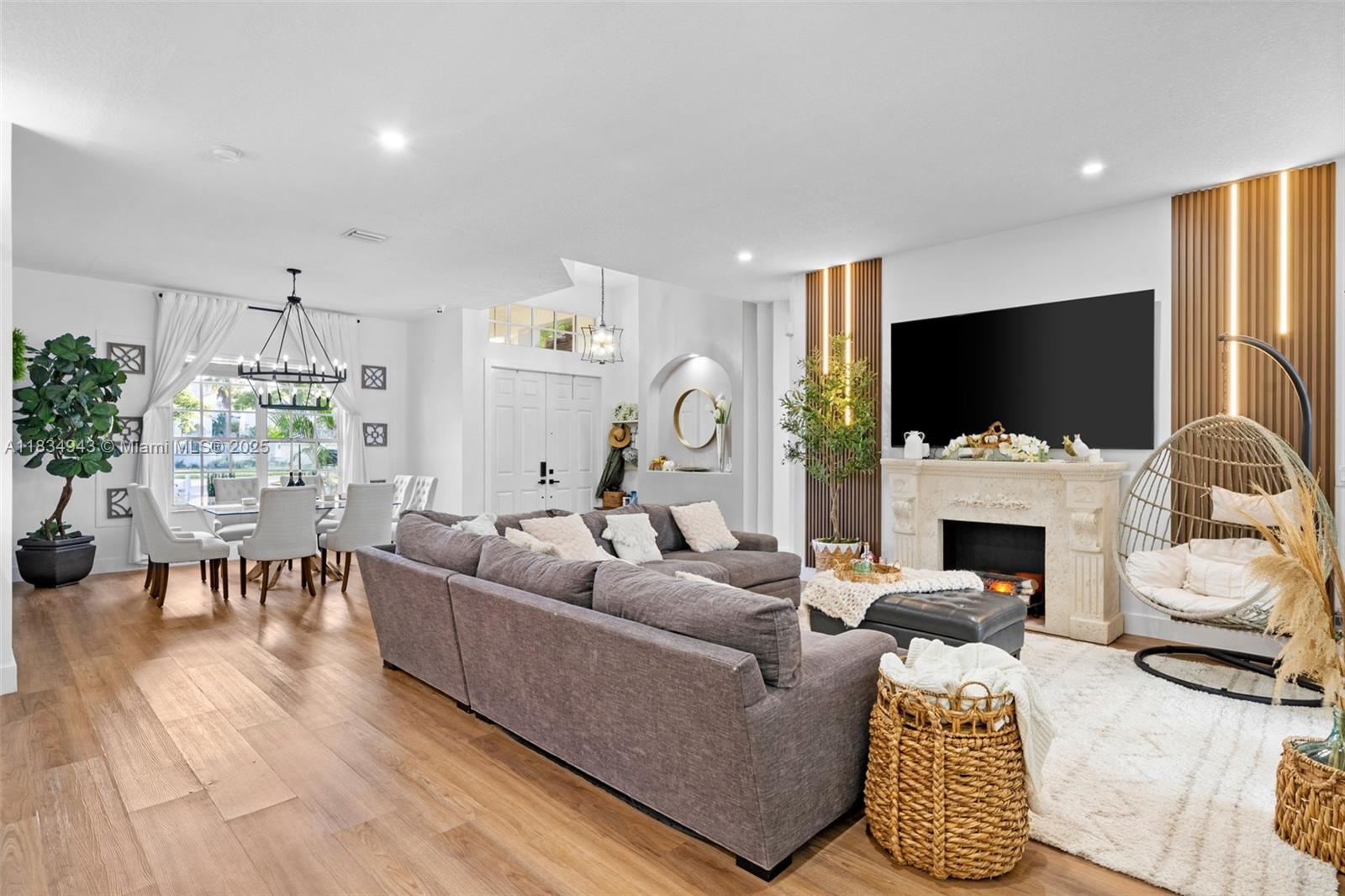 14501 Southwest 33rd Court Miramar, FL 33027 - Photo 10 of 91 a living room with furniture a flat screen tv and a fireplace