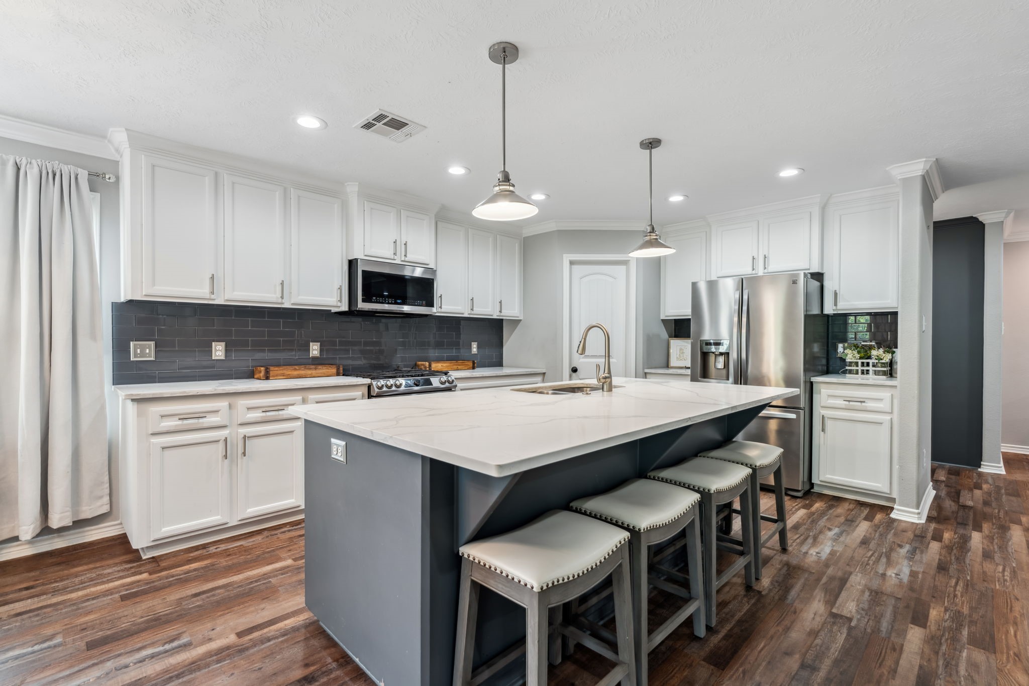 129 Bridgepoint Onalaska, TX 77360 - Photo 9 of 35 a kitchen with kitchen island granite countertop a sink a center island and stainless steel appliances