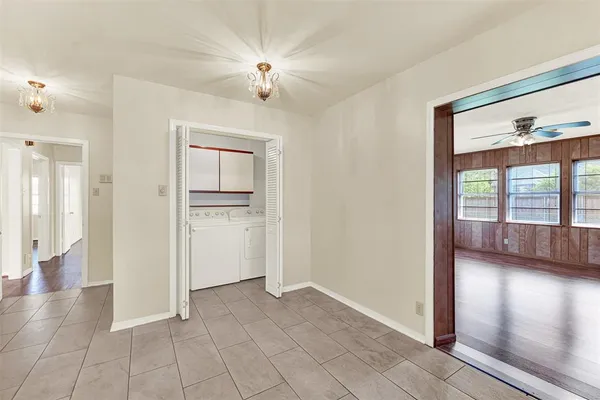 a view of an empty room with window and cabinet