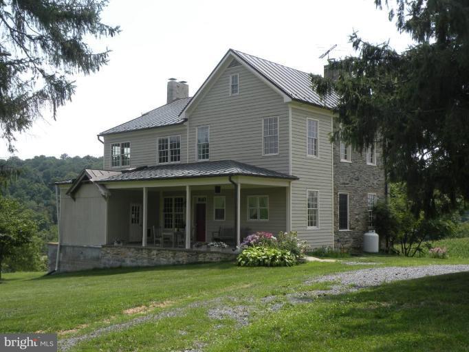 a front view of a house with a garden and porch
