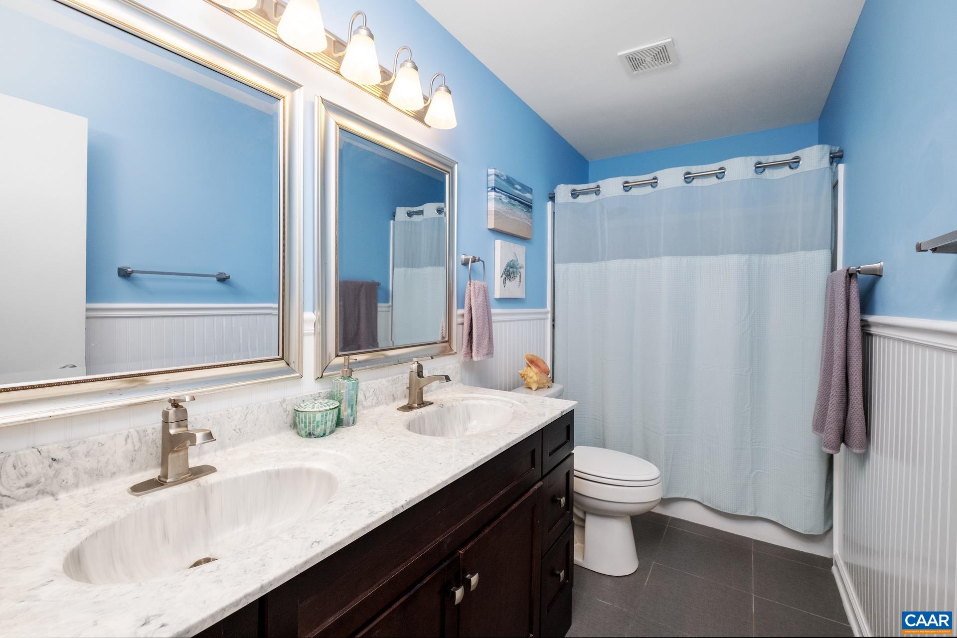 17 Jonquil Road Ruckersville, VA 22968 - Photo 22 of 33 a bathroom with a double vanity sink mirror double and shower
