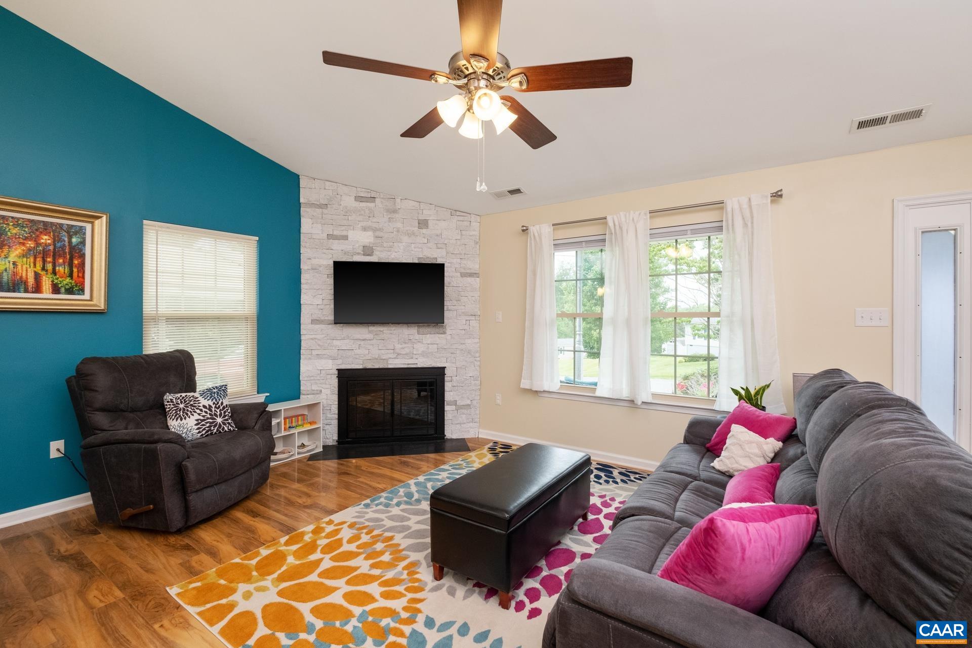 17 Jonquil Road Ruckersville, VA 22968 - Photo 7 of 33 a living room with furniture a flat screen tv and a fireplace