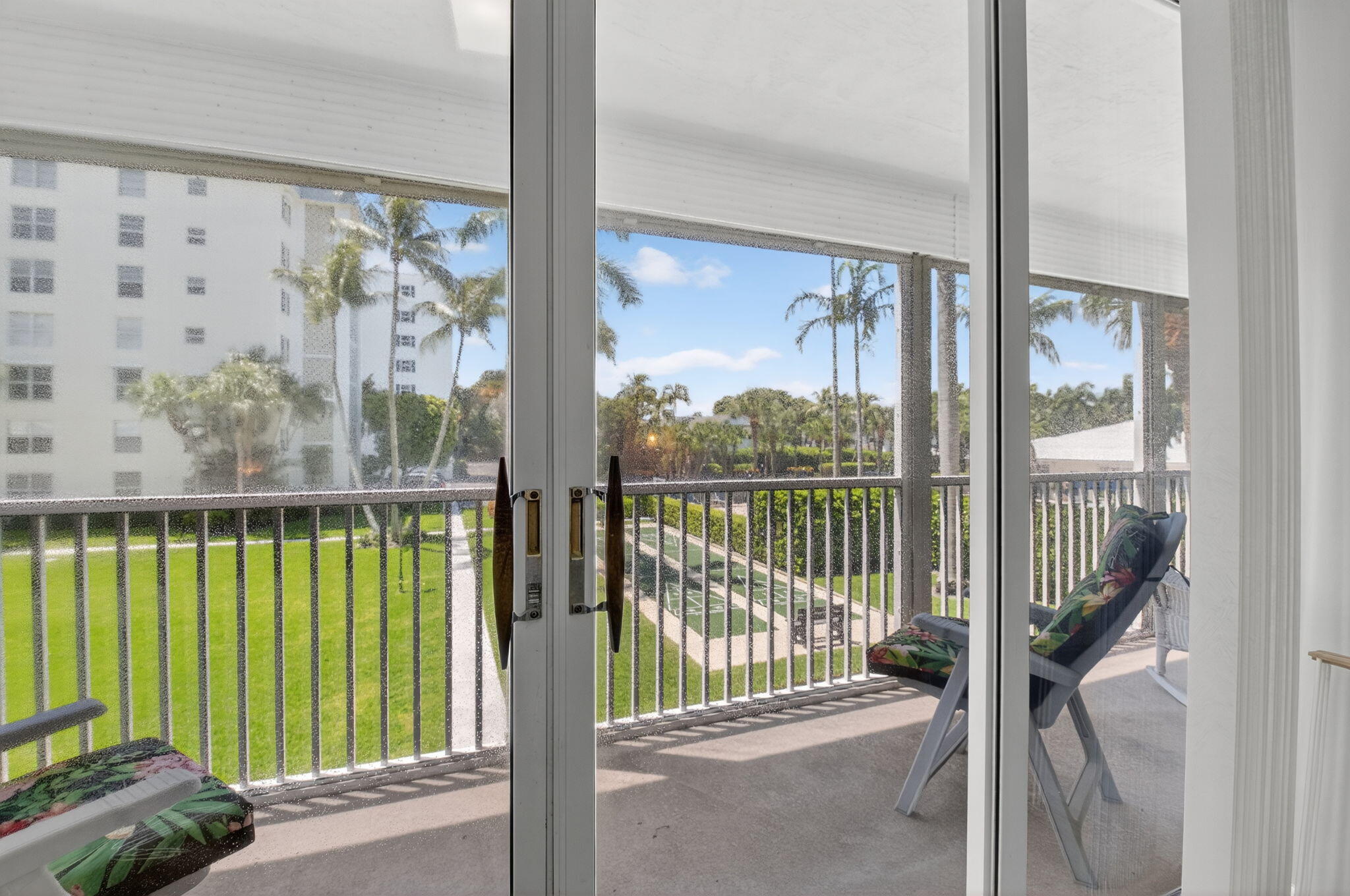 1 Harbourside Drive, Unit 4205 Delray Beach, FL 33483 - Photo 29 of 97 a view of a balcony with a floor to ceiling window and wooden floor