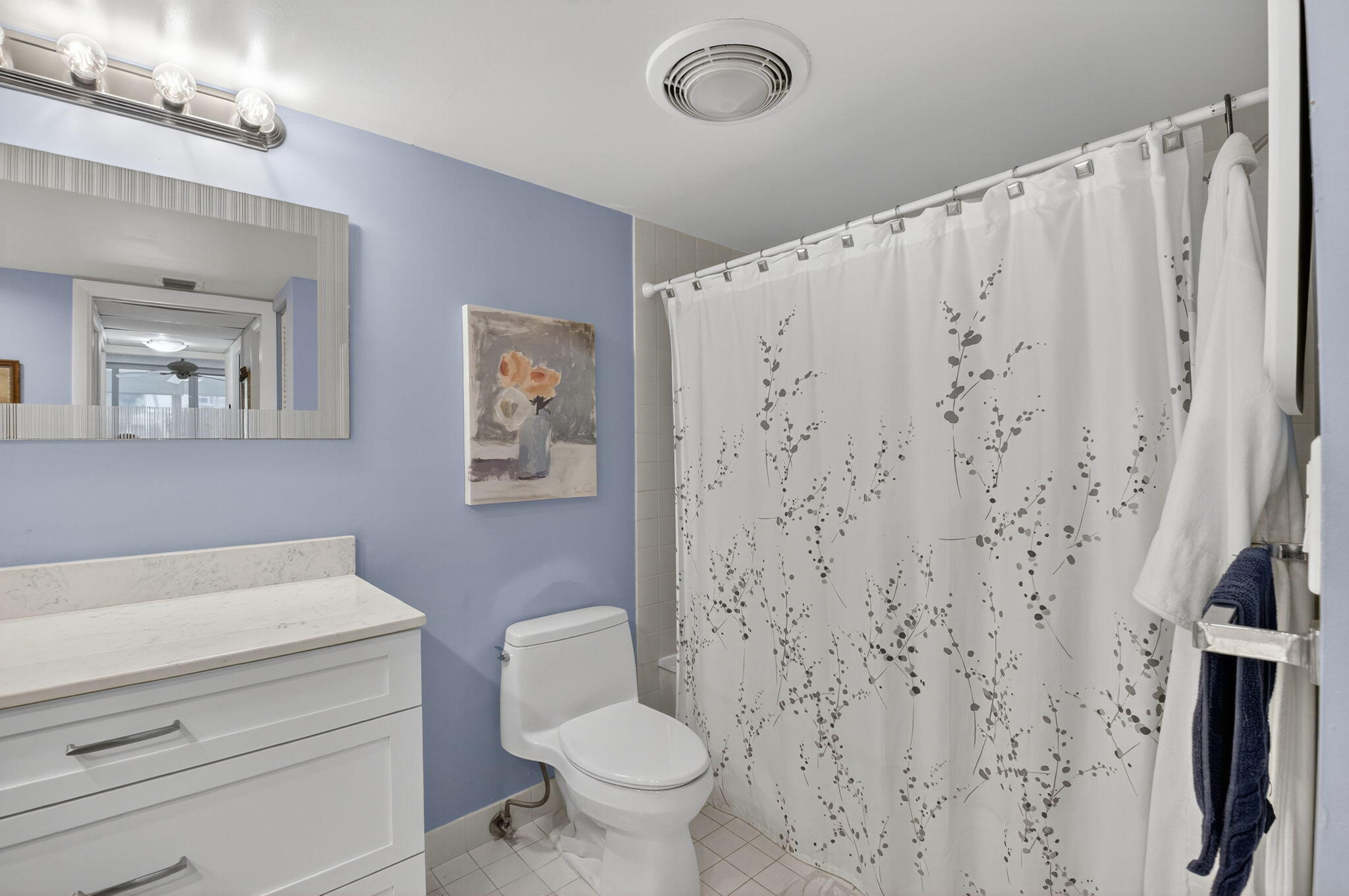 1 Harbourside Drive, Unit 4205 Delray Beach, FL 33483 - Photo 32 of 97 a bathroom with a shower curtain and a toilet