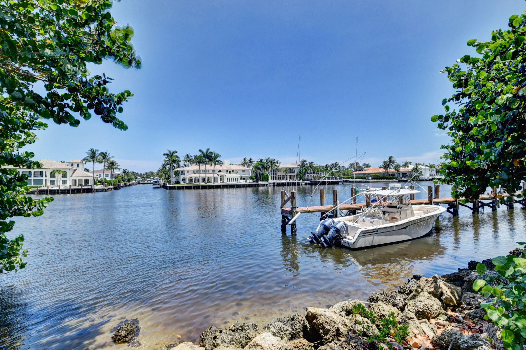 1 Harbourside Drive, Unit 4205 Delray Beach, FL 33483 - Photo 56 of 97 a view of a lake with boats and trees in the background